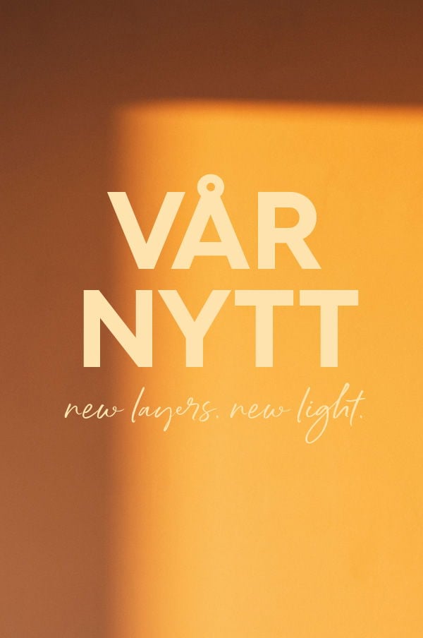 Vårnytt med texten "new layers. new light." på en mjuk orange bakgrund, som skapar en varm och inbjudande atmosfär.