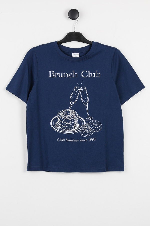 Mörkblå t-shirt med texten "Brunch Club" och illustration av pannkakor och champagneglas, designad för avslappnade söndagar sedan 1993. Perfekt för brunchälskare.