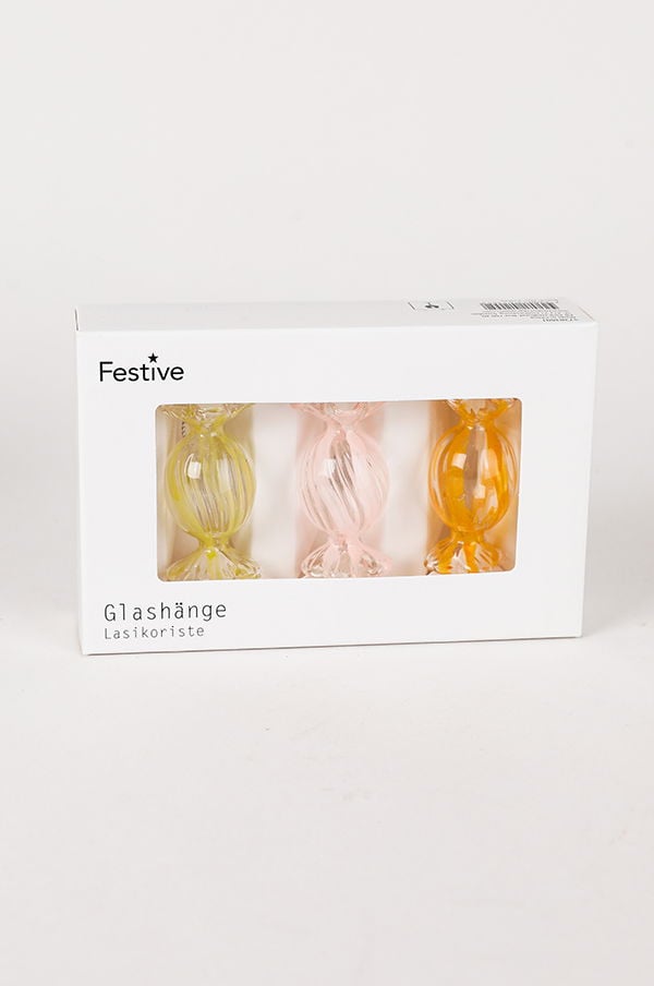 Färgglad glasprydnad i form av godisar, förpackad i en vit låda med texten "Festive". Innehåller tre stycken: gul, rosa och orange. Perfekt för dekoration under festliga tillfällen.
