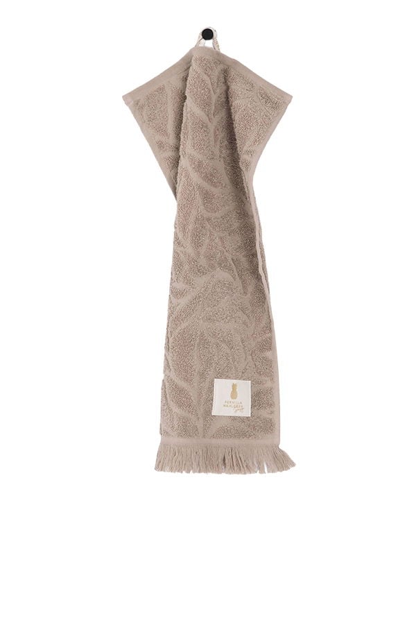 Handduk i beige med mönster av blad och fransar, perfekt för kök eller badrum. Designad för både stil och funktionalitet.